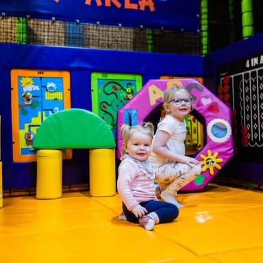 Little girls playing in the bright and colourful soft play area at High Rise Lisburn
