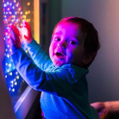 Baby boy amazed by lights in the sensory rooms at High Rise Lisburn